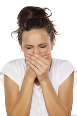 woman has a pain in her mouth and covered it with her hands