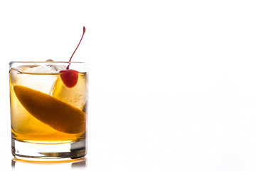 Old fashioned cocktail with cherry and orange peel