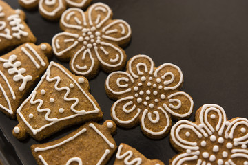 decorated gingerbread on baking sheet