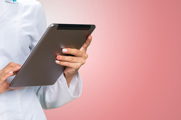 Close-up of a doctor holding a digital tablet