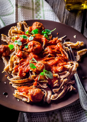 Pasta with seafood on old wooden table.