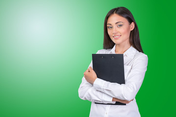Fototapeta premium Young business woman standing with her clipboard
