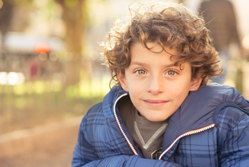 Portrait of young boy, winter dressed and looking at the camera.