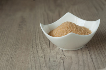 cane brown sugar in white bowl