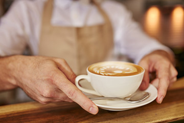 Close up of man serving coffee