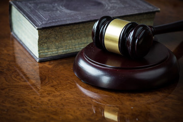 Wooden gavel and book on wooden table
