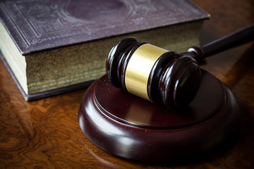 Wooden gavel and book on wooden table
