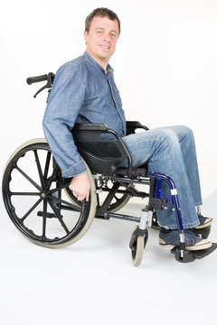 Full length portrait of disabled man on wheelchair over a white background