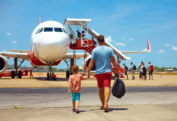 family walking for boarding on plane in airport, summer vacation - obrazy, fototapety, plakaty
