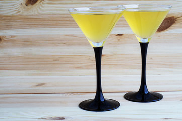 Two cocktails glasses on a wooden background