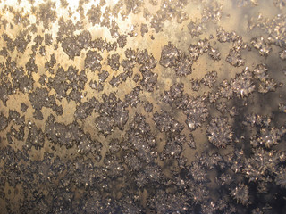Frost on the window in the sunset