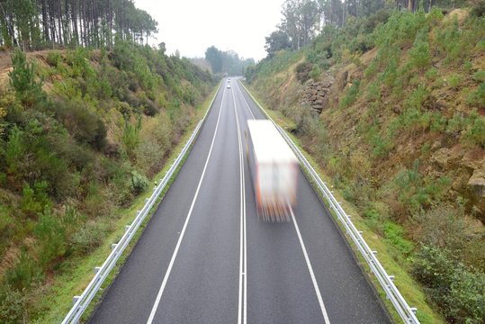 blurred image of truck in motion on highway