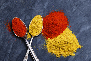 seasoning spice turmeric and paprika on a black stone