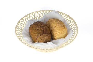 Dark and white buns in a basket isolated