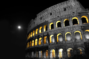 The Rome Colosseum at night. B&W with existing light reflecting through openings.