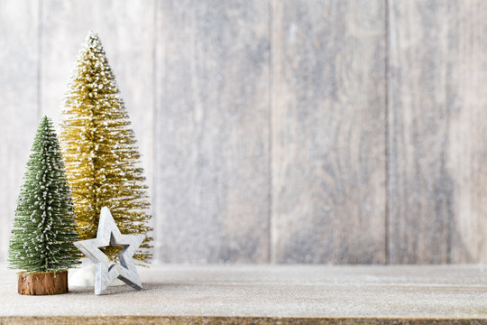 Artificial Christmas tree on a wooden background.