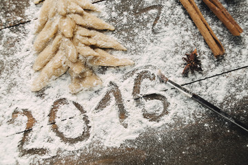 Christmas tree with flour on the wooden table