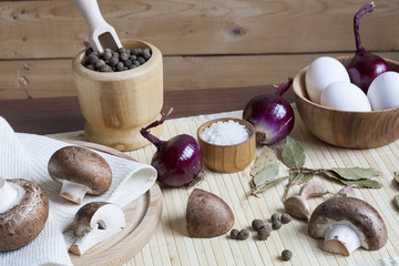 Obraz na płótnie Canvas Fresh eggs with champignon mushrooms, vegetables and spices