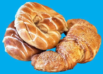 Pretzels and Croissant Puff Pastry Sprinkled with Sesame Seeds, Isolated on Blue Background.
