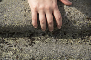 Glacial groove in granite bedrock, including a woman's hand for scale, on Mt. Kearsarge, New Hamp