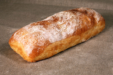 white bread lies on a grey linen tablecloth