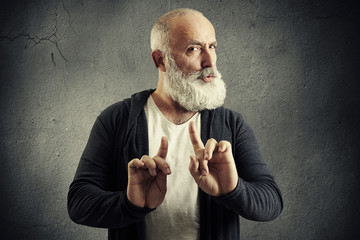 senior bearded man showing refusal sign