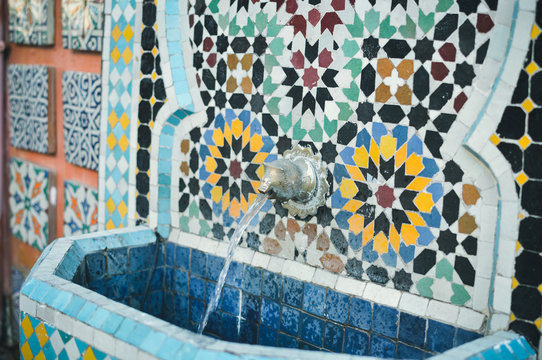 Wonderful Moroccan street drinking fountain with traditional tile mosaic pattern