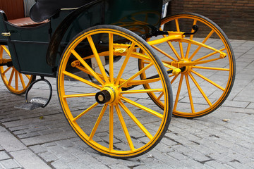Yellow wheel of horse carriage