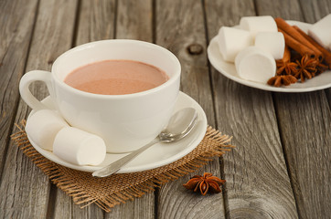 Hot chocolate with marshmallows on the rustic wooden table