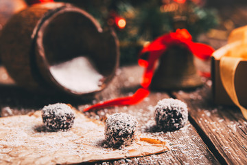 Coconut chocolate balls with Christmas decoration in a background