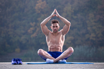 fitness man meditating outdoor