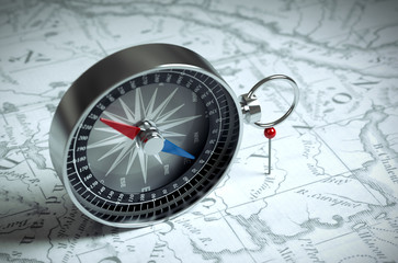 Fototapeta na wymiar Compass On The Map And Red Pin