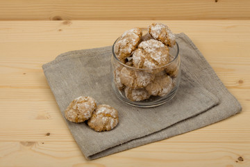 Italian cookies amaretti in jar on linen napkin