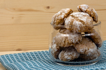 Italian cookies in glass jar on cotton napkin