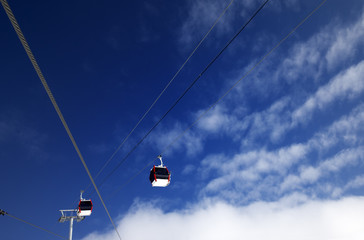 Gondola lifts at ski resort and blue sky with clouds in nice day