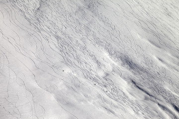 Off-piste slope with snowboarders and skiers