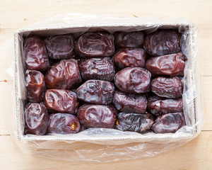 Dates fruits in box, top view.