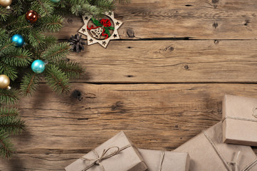 Branch of a Christmas tree with toys on wooden surface