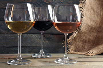 Composition of wine glasses on wooden background