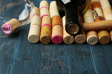 Bottle of wine and corks on wooden table
