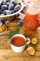 Plum Juice in jar and mug with fresh fruits