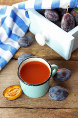 Plum Juice in a mug with fresh fruits