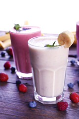 Glasses of fresh cold smoothie with fruit and berries, isolated on white