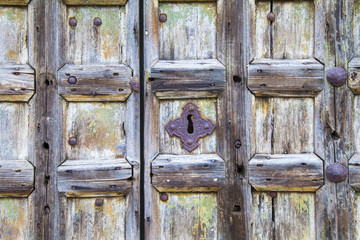 Old wooden door with rusty handles