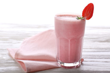 Milkshake with napkin on wooden background