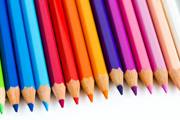 Fototapeta premium Line of colored pencils, white background.