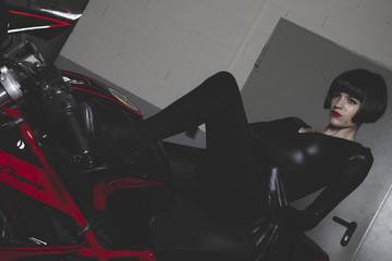motorcycle, brunette with latex suit mounted on a bike with a mo