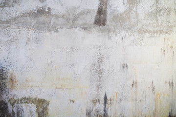 Weathered, stained and dirty gray concrete wall texture background.