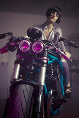 Plakat brunette with latex suit mounted on a bike with a modern design