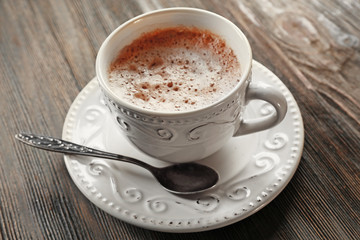 Vintage cup of cacao on wooden background